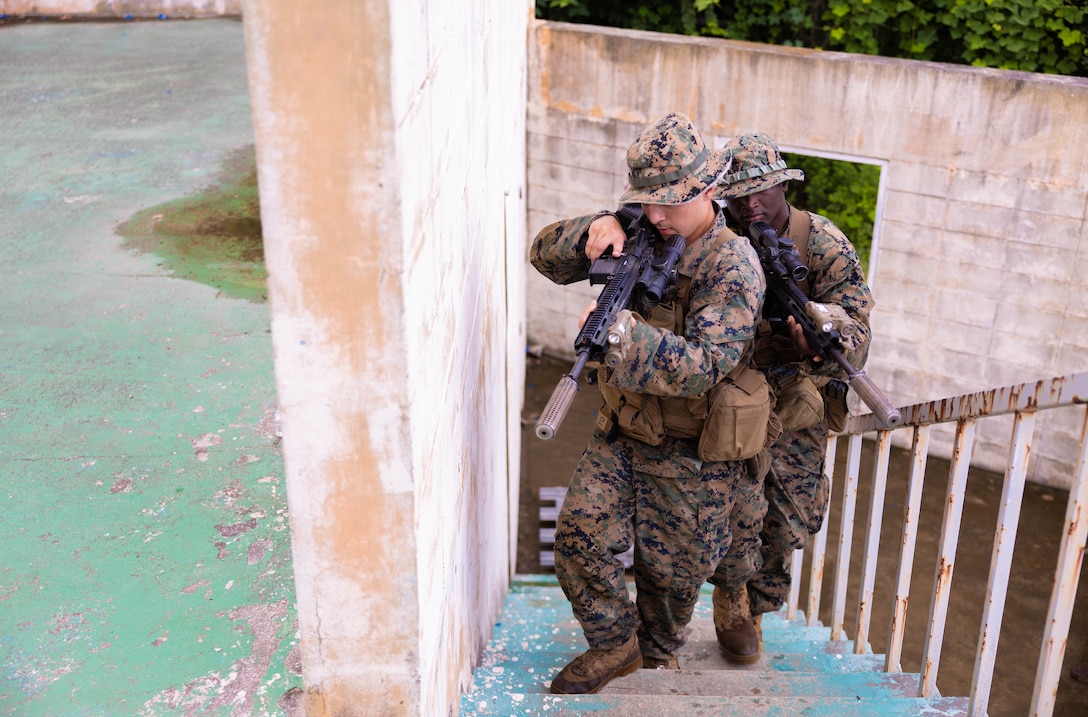 U.S. Marine Corps Lance Cpl. Hector GarciaZamidio and Cpl. Gabriel Moton, both riflemen with Golf Company, 2nd Battalion, 23rd Marines, forward deployed with 4th Marine Regiment, 3rd Marine Division as part of the Unit Deployment Program, prepare to breach a doorway during the Korean Marine Exercise Program in Pohang, South Korea, July 21, 2025. KMEP is conducted regularly between the ROK and U.S. Marine Corps to increase their combined capabilities through realistic training geared towards deterring threats and maintaining peace in the Indo-Pacific. GarciaZamidio and Moton are natives of Alabama. (U.S. Marine Corps photo by Cpl. Kanoa Thomas)