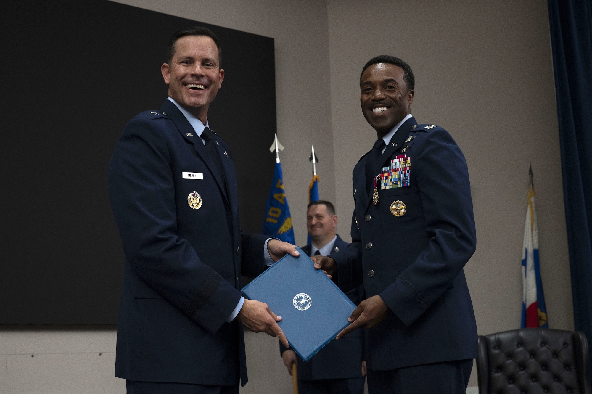 Col. Silas Darden receives the Legion of Merit and accompanying certificate from Brig. Gen. Kevin Merrill, 10th Air Force commander, prior to the 960th Cyberspace Wing change of command ceremony at JBSA-Lackland, Texas on July 12, 2025. (US Air Force photo by TSgt Melissa Estevez)