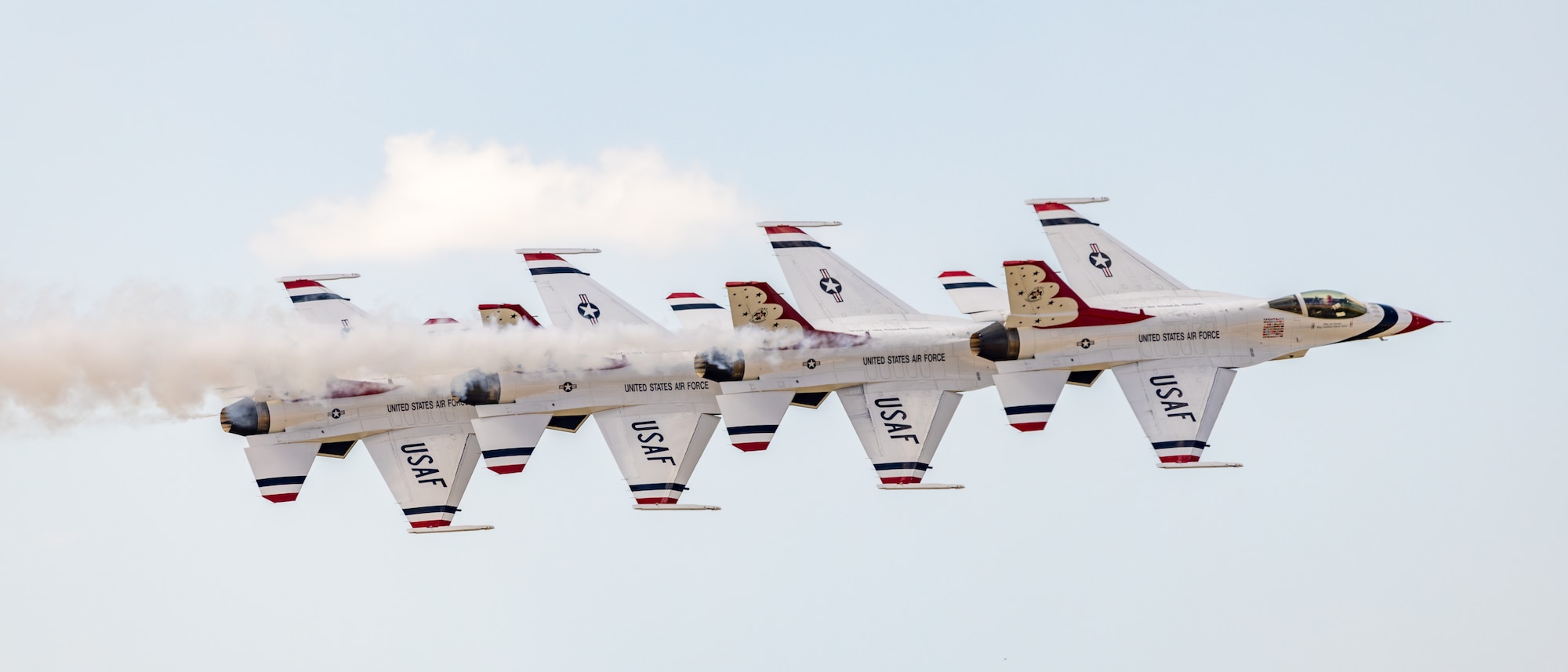 Four aircraft flying in sky.