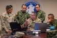 U.S. Army Chief Warrant Officer 4 Alexander Fraire, middle, senior geospatial warrant officer with the 512th Geospatial Engineering Detachment, Headquarters and Headquarters Battalion, U.S. Army South, demonstrates and explains the geospatial data capturing platform used by his unit during a combined geospatial subject matter expert exchange (SMEE) at Fort Sam Houston, Texas, July 23, 2025. The SMEE, hosted by 512th Geospatial Engineer Detachment, Headquarters and Headquarters Battalion, U.S. Army South, focused on building interoperability and partner capacity in geospatial engineering. (U.S. Army photo by Sgt. Joshua Taeckens)
