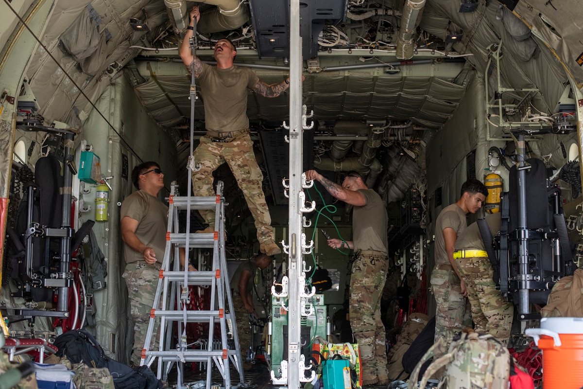 U.S. Air Force Airmen assigned to the 374th Airlift Wing and 18th Air Evacuation Squadron rig a C-130J Super Hercules for a mass casualty exercise