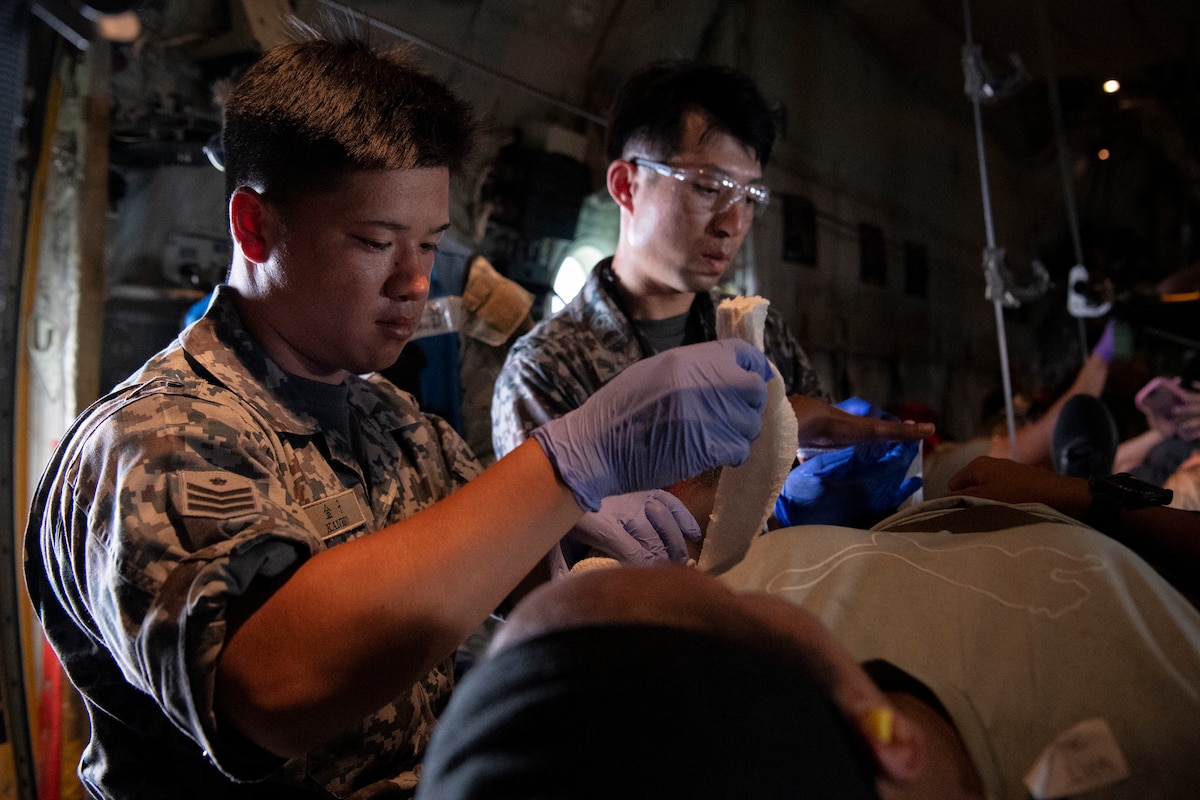 Personnel assigned to the Japan Air Self-Defense Force Misawa Medical Squadron execute in-flight patient care onboard a U.S. Air Force C-130J Super Hercules assigned to the 36th Airlift Squadron for a mass casualty exercise,