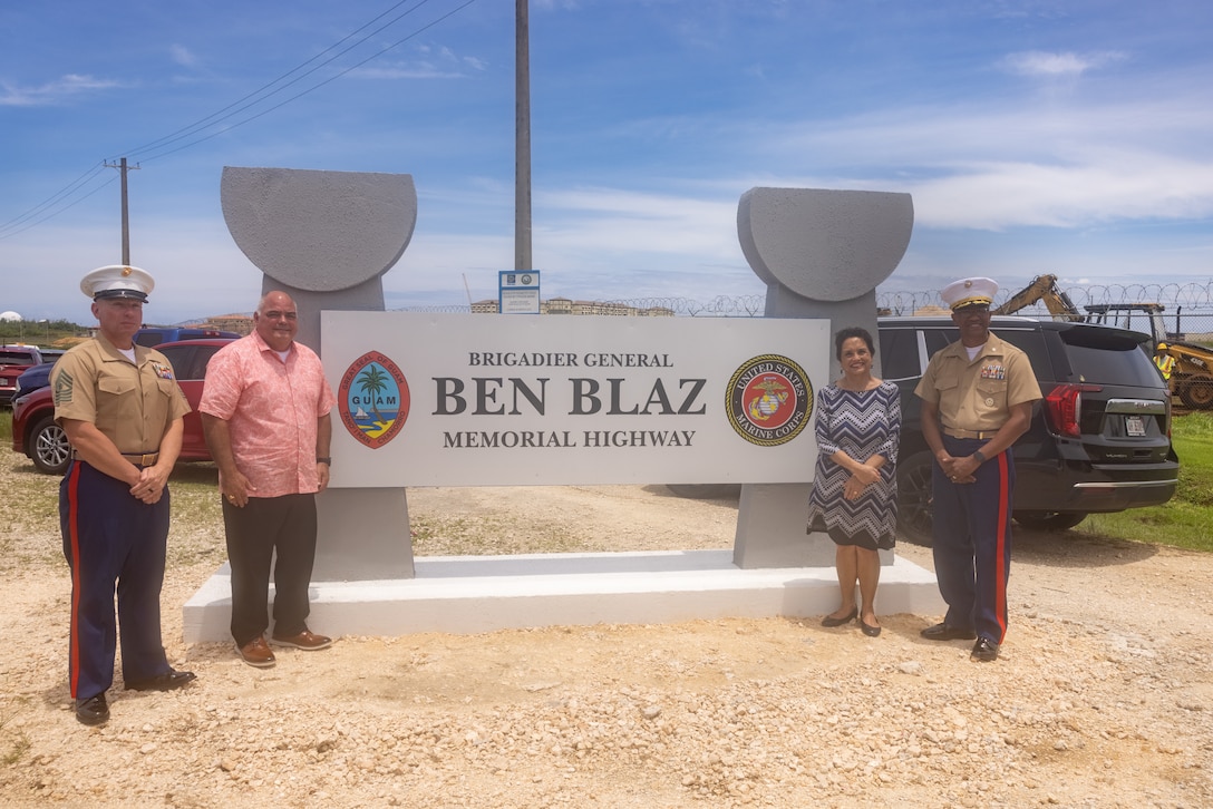 From left to right, U.S. Marine Corps Master Gunnery Sgt. Christopher Krivenko, acting senior enlisted advisor of Marine Corps Base Camp Blaz, Senator Chris Dueñas, the Honorable Lourdes A. Leon Guerrero, Governor of Guam and U.S. Marine Corps Col. Richard D. Marshall Jr., commanding officer of MCB Camp Blaz, pose for a photo at the new highway sign during the Brig. Gen. Ben Blaz Memorial Highway renaming ceremony in Dededo, Guam, July 28, 2025. The naming of Brig. Gen. Ben Blaz Memorial Highway is a heartfelt tribute to a distinguished individual who represents the dedication to service, professionalism, and local pride that Camp Blaz aspires to uphold. (U.S. Marine Corps photo by Lance Cpl. Afton Smiley)