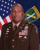 Command Chief Warrant Officer, U.S. Army Civil Affairs and Psychological Operations Command (ABN) poses for his command photo in front of the Unitd States and USACAPOC(A) flags