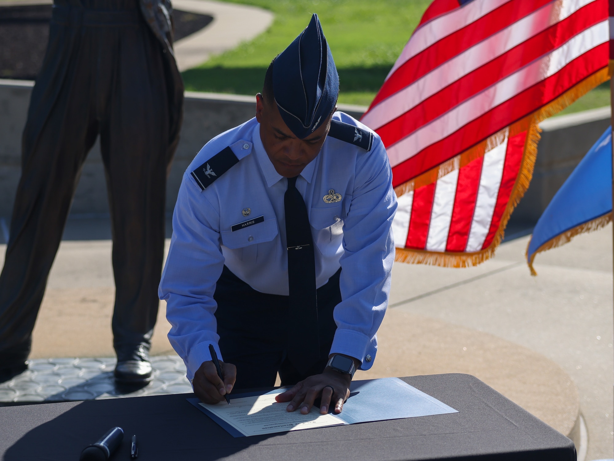 Man signs document.