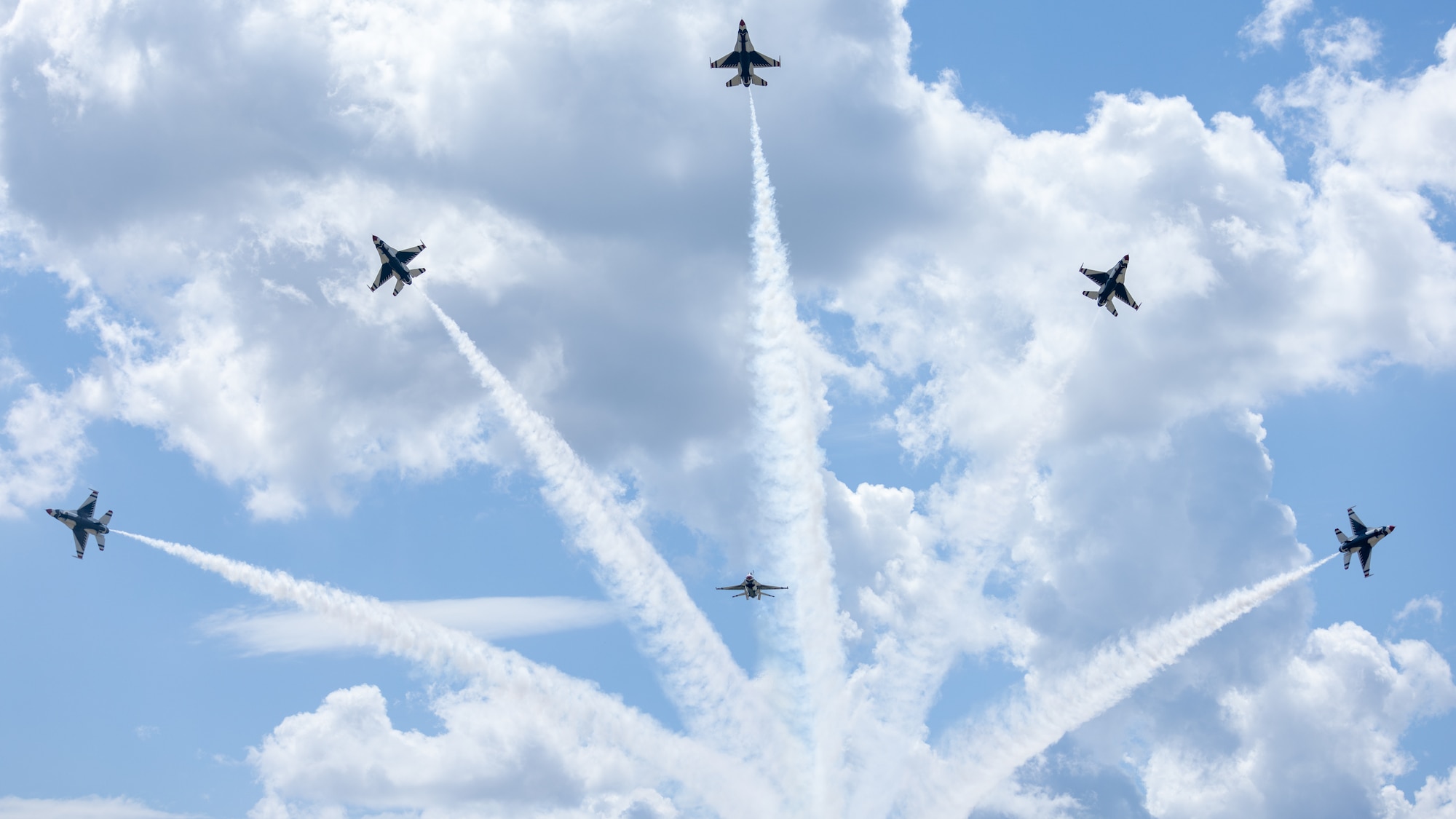 Five aircraft fly in sky.