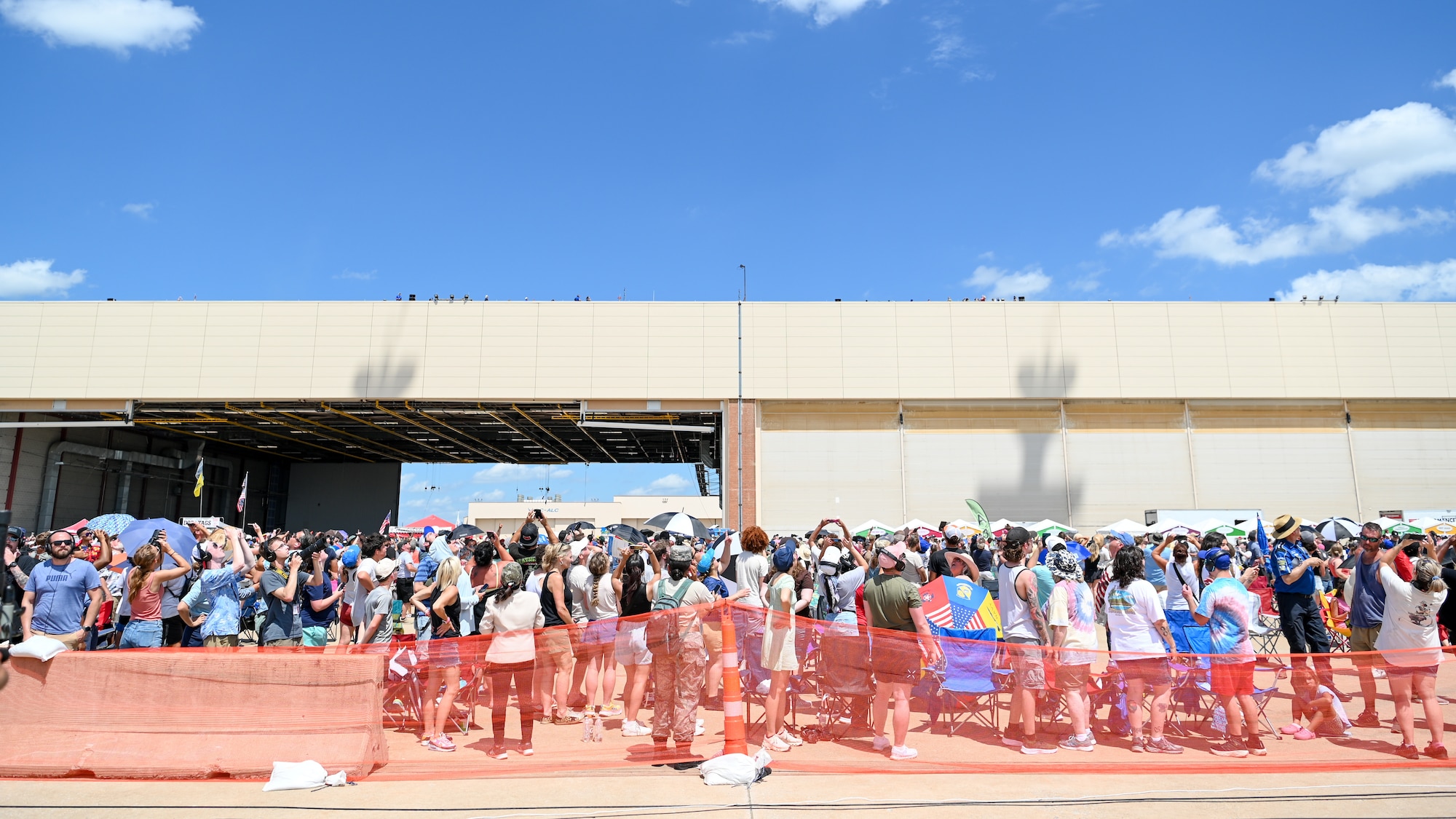 Shadow of aircraft is seen over crowd.