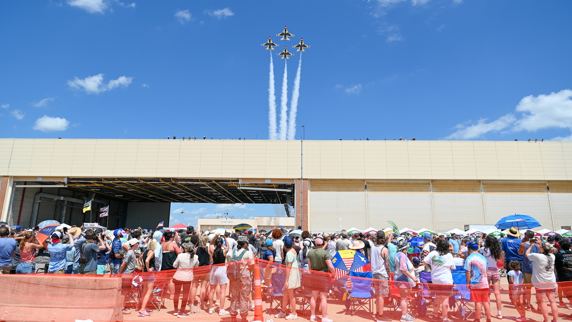 Aircraft flying over crowd.
