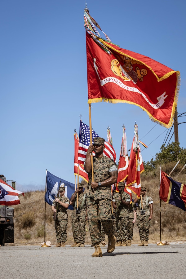 U.S. Marine Corps Sgt. Maj. Theodore Ingram III, command senior enlisted leader of I Marine Expeditionary Force Information Group, retrieves the organizational colors during a change of command ceremony at Marine Corps Base Camp Pendleton, California, July 25, 2025. The ceremony symbolized the transfer of authority and responsibility of I MIG from Col. William V. Osborne III to Col. William E. DeLeal II. (U.S. Marine Corps photo by Cpl. Peyton Kahle)