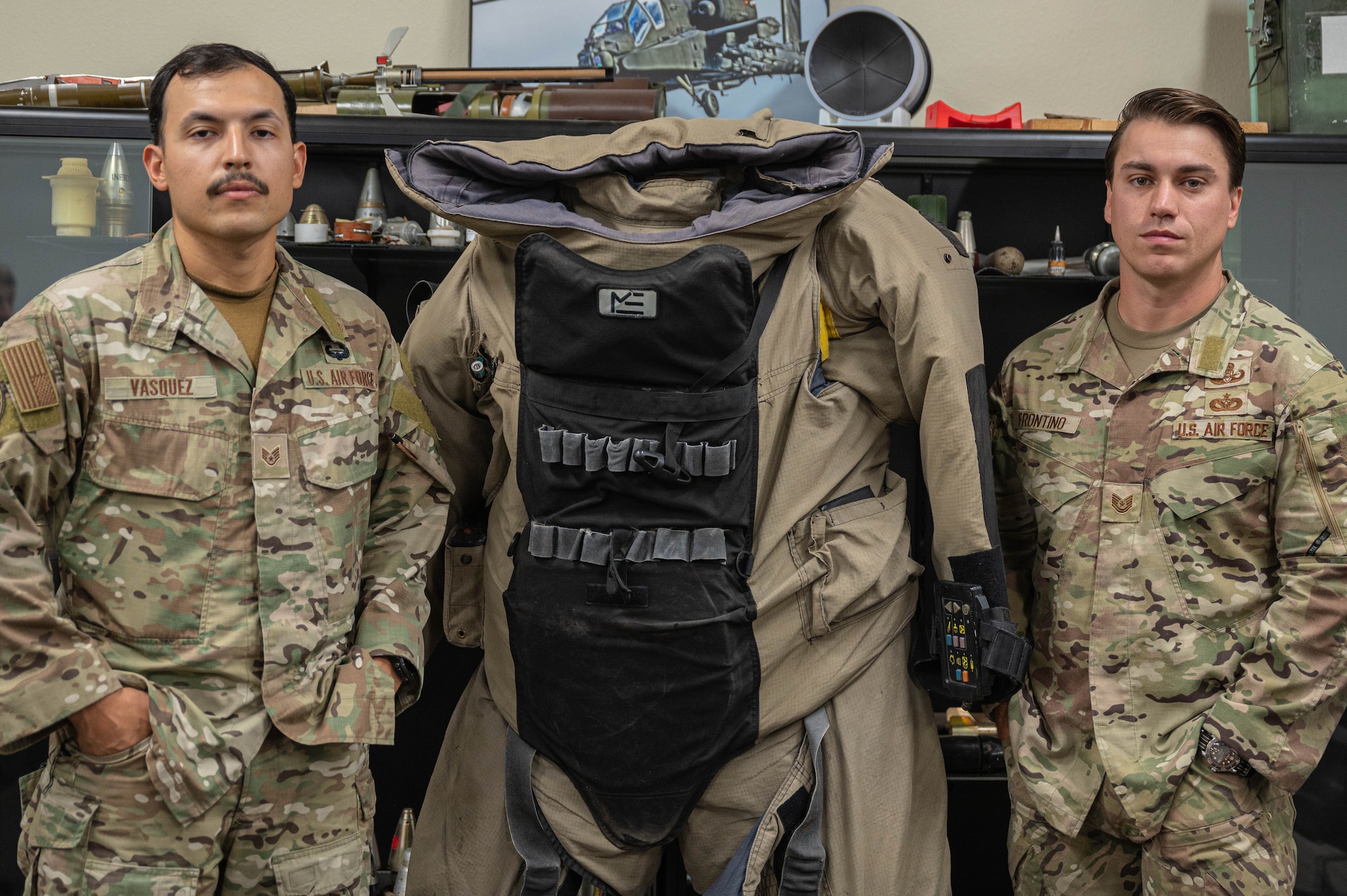 U.S. Air Force Tech. Sgt. Nicholas Frontino (right), 56th Civil Engineer Squadron noncommissioned officer in charge of explosive ordnance disposal operations, and Staff Sgt. Jacobo Vasquez Cuartas (left) 56th CES EOD Team Leader, pose for a photo in the EOD classroom, July 18, 2025, at Luke Air Force Base, Arizona.