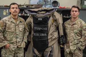 U.S. Air Force Tech. Sgt. Nicholas Frontino (right), 56th Civil Engineer Squadron noncommissioned officer in charge of explosive ordnance disposal operations, and Staff Sgt. Jacobo Vasquez Cuartas (left) 56th CES EOD Team Leader, pose for a photo in the EOD classroom, July 18, 2025, at Luke Air Force Base, Arizona.