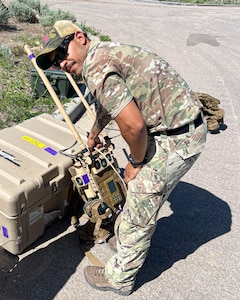 U.S. Air Force Staff Sgt. Jacobo Vasquez Cuartas, 56th Civil Engineer Squadron explosive ordnance disposal operations team leader, grabs a Portable Tactical Robot Controller, May 13, 2025, at Camp Williams, Utah.