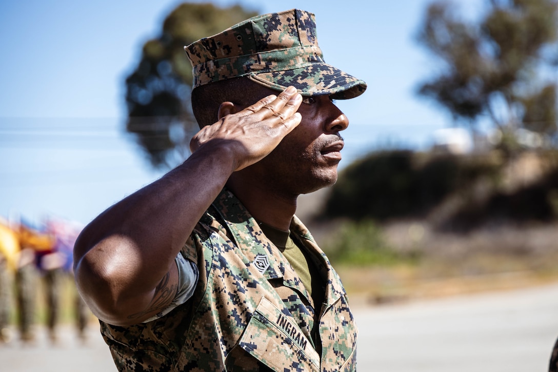 U.S Marine Corps Sgt. Maj. Theodore Ingram III, command senior enlisted leader of I Marine Expeditionary Force Information Group, salutes the colors during a change of command ceremony at Marine Corps Base Camp Pendleton, California, July 25, 2025. The ceremony symbolized the transfer of authority and responsibility of I MIG from Col. William V. Osborne III to Col. William E. DeLeal II. (U.S. Marine Corps photo by Cpl. Peyton Kahle)