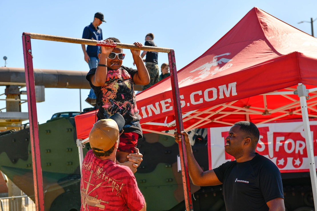NORFOLK, VA (Oct. 19, 2024) - Guests of Naval Station Norfolk's Fleet Fest 2024 conduct pull-ups at the United States Marine Corps booth.