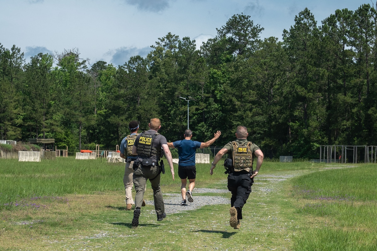 A group of men conduct an apprehension exercise