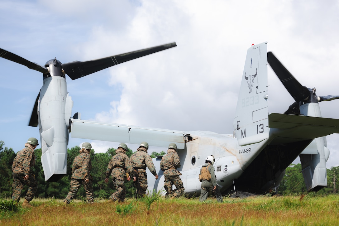 U.S. Navy Reserve Officers’ Training Corps (ROTC) Midshipmen enter an MV-22 Osprey aircraft  with Marine Medium Tiltrotor Squadron 261 (VMM-261) during Fleet Marine Force East (FMF-E) at Marine Corps Base Camp Lejeune, North Carolina, July 17, 2025. 2nd Battalion, 2nd Marine Regiment provided coordination and safety support during FMF-E, a training event with the purpose of familiarizing NROTC Midshipmen who have committed to becoming Marine Corps officers with the primary communities they may serve in. (U.S. Marine Corps photo by Sgt. Jorge Borjas)