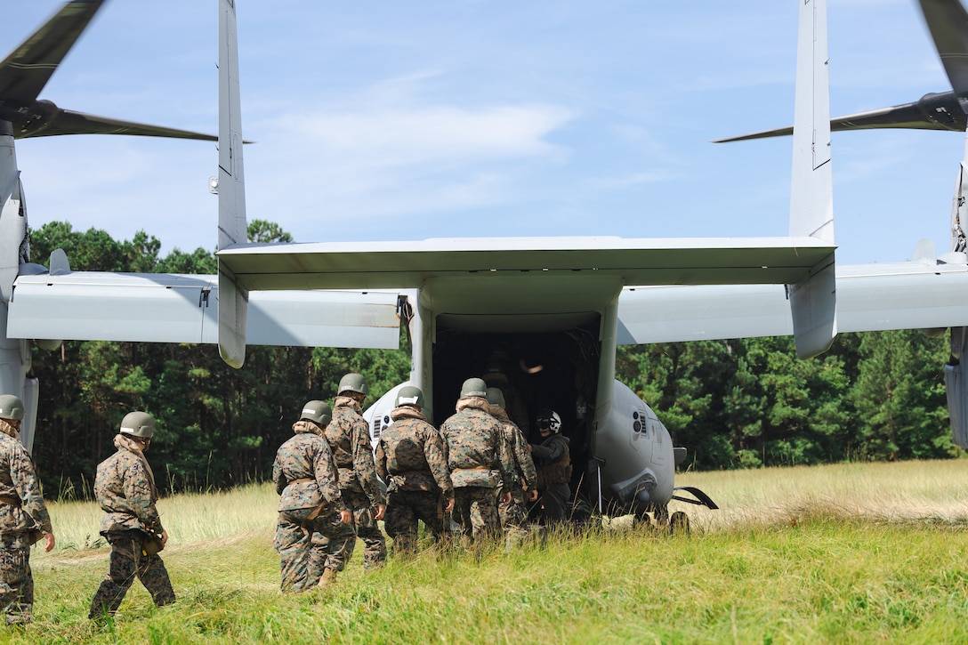 U.S. Navy Reserve Officers’ Training Corps (ROTC) Midshipmen enter an MV-22 Osprey aircraft  with Marine Medium Tiltrotor Squadron 261 (VMM-261) during Fleet Marine Force East (FMF-E) at Marine Corps Base Camp Lejeune, North Carolina, July 17, 2025. 2nd Battalion, 2nd Marine Regiment provided coordination and safety support during FMF-E, a training event with the purpose of familiarizing NROTC Midshipmen who have committed to becoming Marine Corps officers with the primary communities they may serve in. (U.S. Marine Corps photo by Sgt. Jorge Borjas)