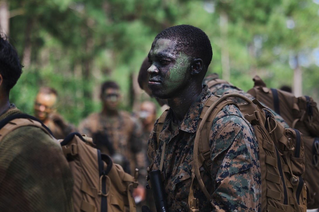 A U.S. Navy Reserve Officers’ Training Corps (ROTC) Midshipman takes part in a patrol during Fleet Marine Force East (FMF-E) at Marine Corps Base Camp Lejeune, North Carolina, July 17, 2025.  2nd Battalion, 2nd Marine Regiment provided coordination and safety support during FMF-E, a training event with the purpose of familiarizing NROTC Midshipmen who have committed to becoming Marine Corps officers with the primary communities they may serve in. (U.S. Marine Corps photo by Sgt. Jorge Borjas)