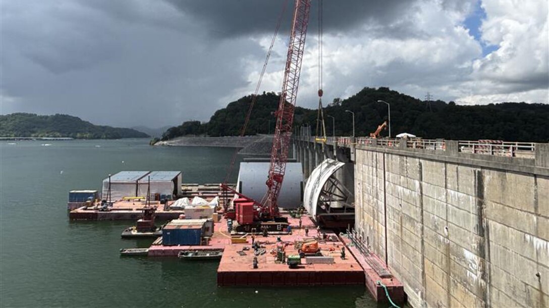 Work crews successfully remove the first massive spillway gate from Center Hill Dam July 26, 2025, on the Caney Fork River in Lancaster, Tennessee. The U.S. Army Corps of Engineers Nashville District and its contractor, American Bridge Company, hoisted the 37-feet high by 50-feet wide gate and placed it on a work barge on Center Hill Lake. This action signals the modernization of the dam's infrastructure, replacing all eight original tainter gates and lifting equipment that have been in continuous operation since 1948. (USACE Photo by Mike Freeman)