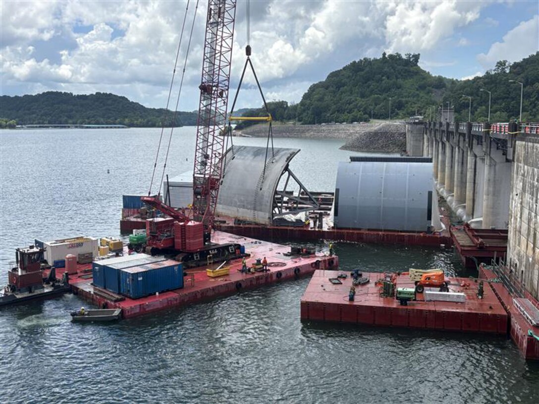 Work crews successfully remove the first massive spillway gate from Center Hill Dam July 26, 2025, on the Caney Fork River in Lancaster, Tennessee. The U.S. Army Corps of Engineers Nashville District and its contractor, American Bridge Company, hoisted the 37-feet high by 50-feet wide gate and placed it on a work barge on Center Hill Lake. This action signals the modernization of the dam's infrastructure, replacing all eight original tainter gates and lifting equipment that have been in continuous operation since 1948. (USACE Photo by Mike Freeman)