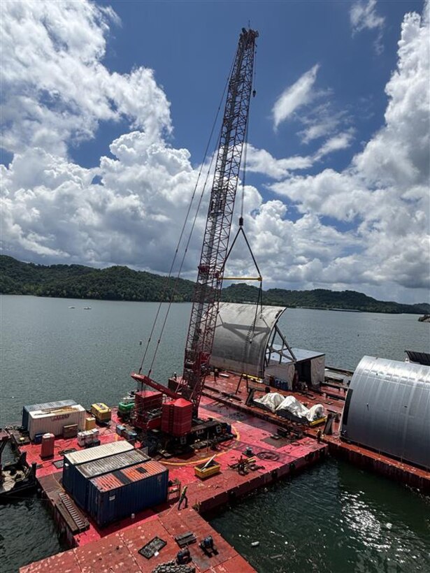 Work crews successfully remove the first massive spillway gate from Center Hill Dam July 26, 2025, on the Caney Fork River in Lancaster, Tennessee. The U.S. Army Corps of Engineers Nashville District and its contractor, American Bridge Company, hoisted the 37-feet high by 50-feet wide gate and placed it on a work barge on Center Hill Lake. This action signals the modernization of the dam's infrastructure, replacing all eight original tainter gates and lifting equipment that have been in continuous operation since 1948. (USACE Photo by Mike Freeman)