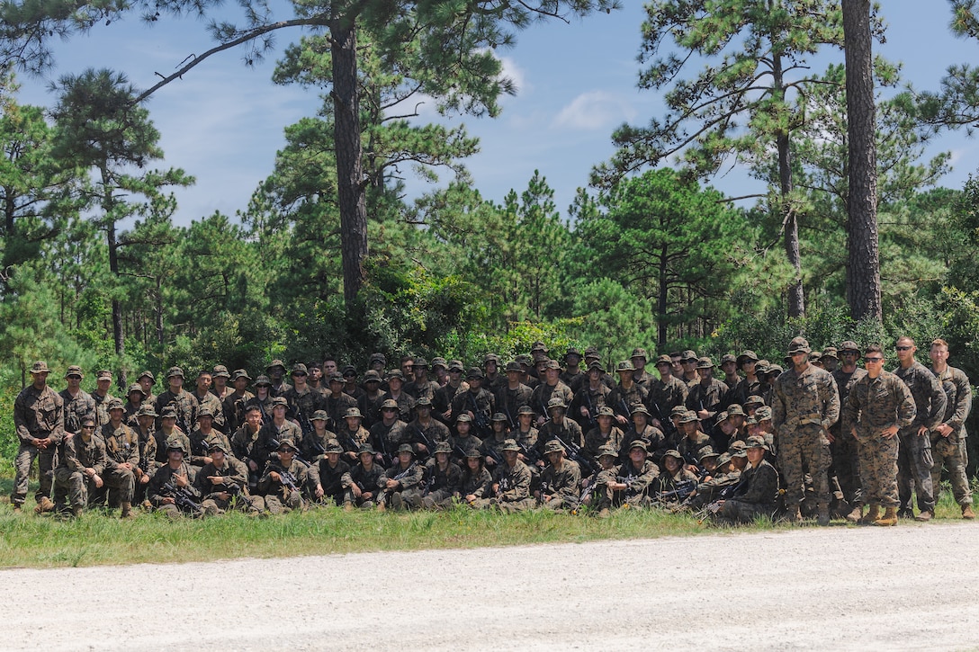 U.S. Marines with various units and U.S. Navy Reserve Officers’ Training Corps (ROTC) Midshipmen pose for a photo during Fleet Marine Force East (FMF-E) at Marine Corps Base Camp Lejeune, North Carolina, July 18, 2025.  2nd Battalion, 2nd Marine Regiment provided coordination and safety support during FMF-E, a training event with the purpose of familiarizing NROTC Midshipmen who have committed to becoming Marine Corps officers with the primary communities they may serve in. (U.S. Marine Corps photo by Sgt. Jorge Borjas)