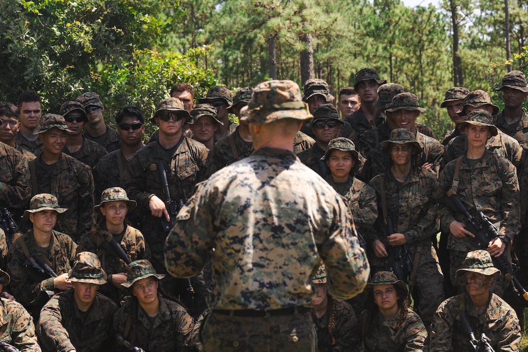 U.S. Navy Reserve Officers’ Training Corps (ROTC) Midshipmen receive feedback after concluding patrol base operations during Fleet Marine Force East (FMF-E) at Marine Corps Base Camp Lejeune, North Carolina, July 18, 2025.  2nd Battalion, 2nd Marine Regiment provided coordination and safety support during FMF-E, a training event with the purpose of familiarizing NROTC Midshipmen who have committed to becoming Marine Corps officers with the primary communities they may serve in. (U.S. Marine Corps photo by Sgt. Jorge Borjas)