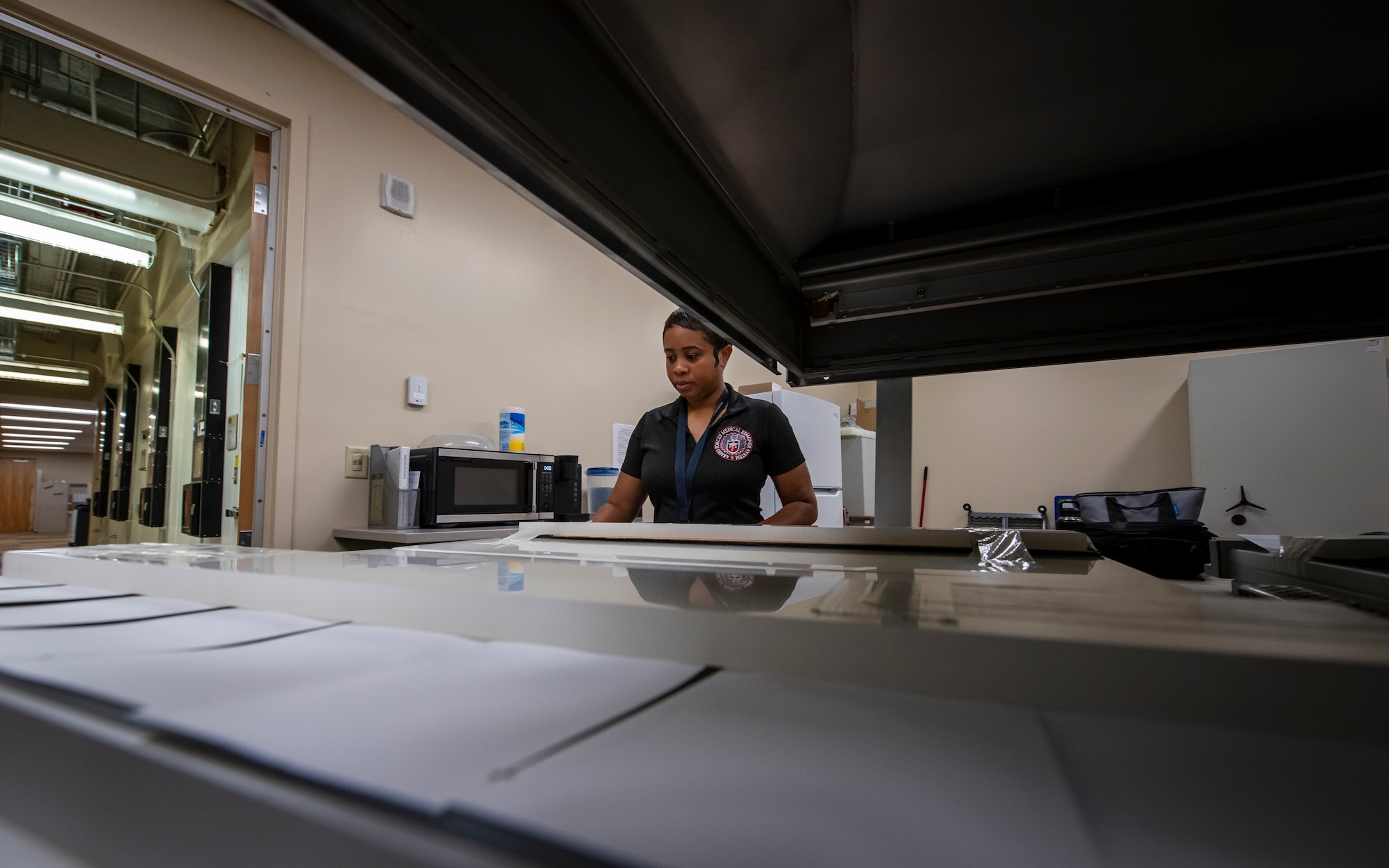 Ms. Tierra Ramos, Armed Forces Repository of Specimen Samples for the Identification of Remains (AFRSSIR) quality control technician, seals DNA blood stain cards in a vacuum sealer before they are boxed and stored at the Armed Forces Medical Examiner System (AFMES), Dover Air Force Base, Delaware, June 27, 2025. Blood stain cards are stored in trays which hold 400 individually vacuumed sealed cards. In just the first half of 2025, over 116,000 DNA blood stain cards were received and processed from the numerous collection sites around the United States, averaging roughly 19,000 per month. (U.S. Air Force photo by Staff Sgt. Noah D. Coger)
