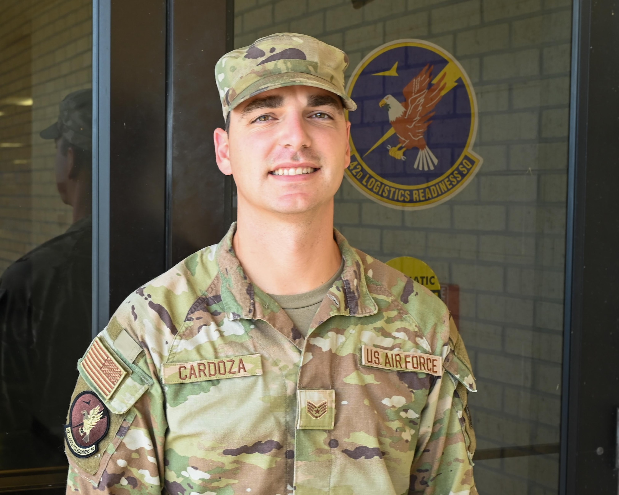 U.S. Air Force Staff Sgt. John Cardoza, 42d Logistics Readiness Squadron noncommissioned officer in charge of outbound cargo, poses for a photo in front of the 42d LRS building at Maxwell Air Force Base, Alabama, July 23, 2025. Cardoza is being recognized as the Crusader of the Month for July for outstanding performance and dedication to the mission. (U.S. Air Force photo by Senior Airman Tanner Doerr)