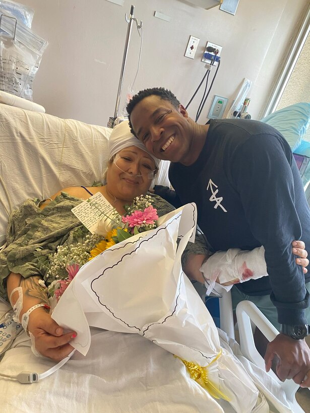 U.S. Navy Hospital Corpsman 2nd Class Sammuel Goodwin, a hospital corpsman with 1st Marine Regiment, 1st Marine Division, poses for a photo with Melinda Gurrola at Hillcrest Medical Center at University of California San Diego Health Hospital, California. Gurrola was in a motorcycle crash that left her severely injured on the I-805 north.