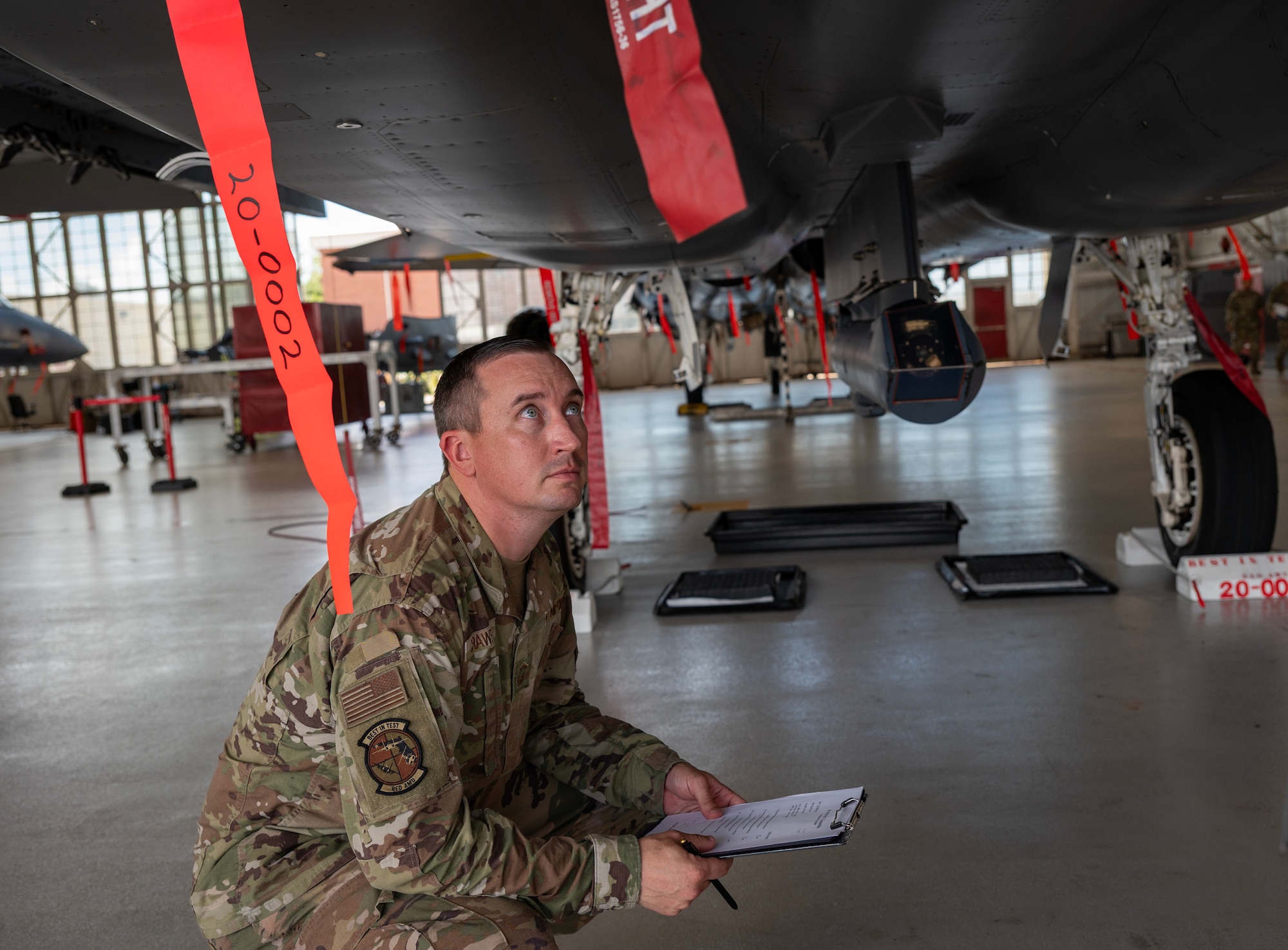 An aircraft maintenance squadron member, inspects an F-15 EX Eagle II.