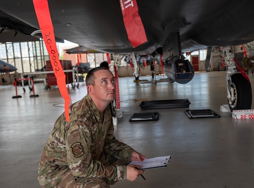 An aircraft maintenance squadron member, inspects an F-15 EX Eagle II.