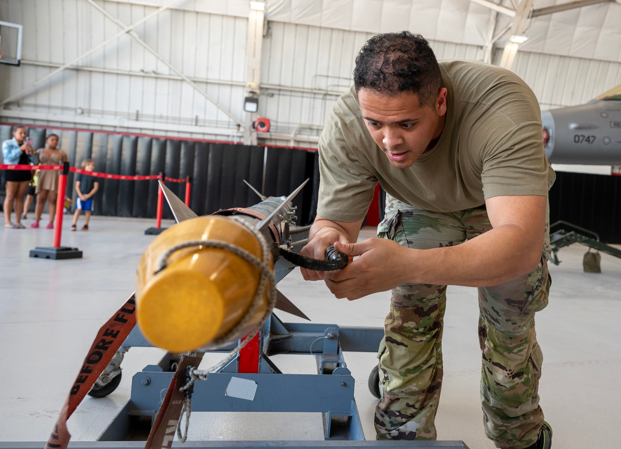A load crew member inspects an AIM-9X Sidewinder.