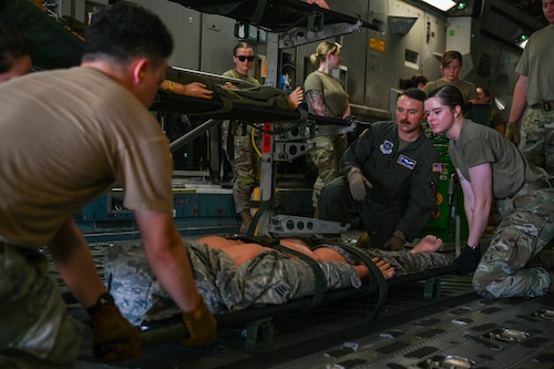 Airmen work on securing a little aboard a C17 Globemaster III.
