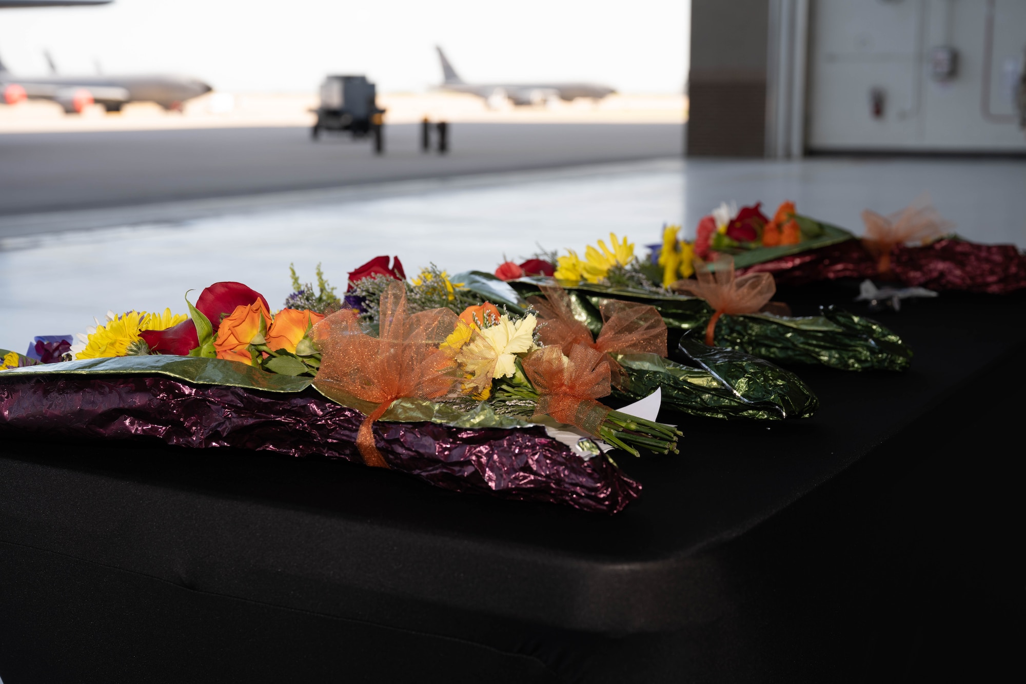 Flowers rest on a table at the 22nd Air Refueling Wing Change of Command ceremony at McConnell Air Force Base, Kansas, July 28, 2025. The flowers were handed to family members of the official party during the ceremony. (U.S. Air Force photo by Airman 1st Class Patrick O’Neill)