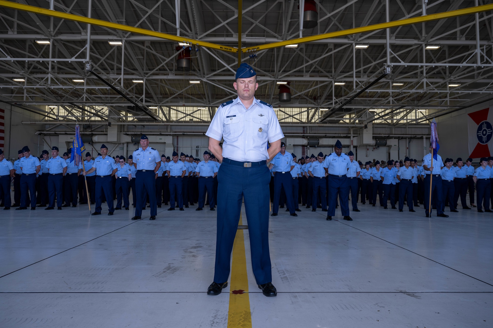 Col. Aaron Strode, 22nd Air Refueling Wing deputy commander, participates in a prayer at McConnell Air Force Base, Kansas, July 28, 2025. The prayer was led by the wing chaplain during the 22nd ARW Change of Command ceremony. (U.S. Air Force photo by Airman 1st Class Patrick O’Neill)