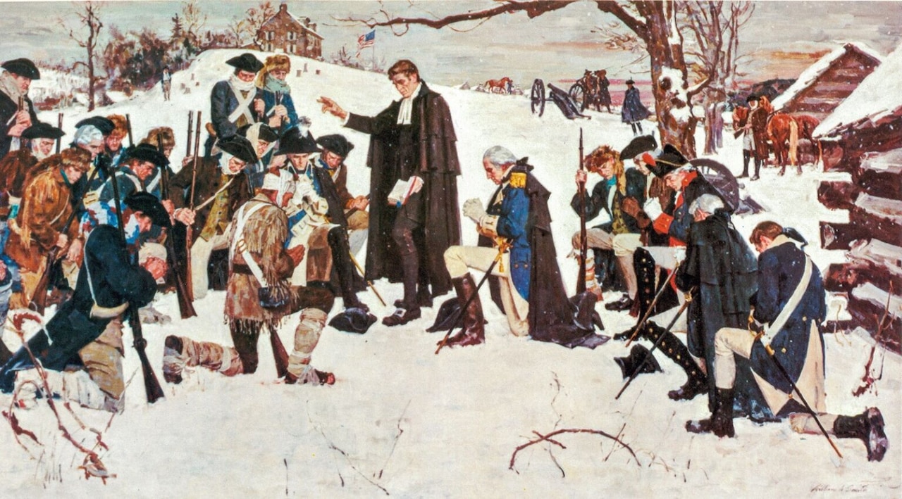 A painting depicts Revolutionary War soldiers praying in the snow. Many are down on one knee. A man in a black robe stands while holding a Bible in his left hand. In the rear are log cabins, cannons, horses, a house on a hill and an American flag.