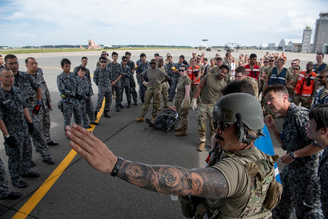 U.S. Air Force Maj. David Stuppy, 18th Air Evacuation Squadron standards and evaluations flight examiner, briefs personnel assigned to the 35th Medical Group and Japan Air Self-Defence Force on aeromedical operations for a mass casualty exercise during Resolute Force Pacific 2025 at Misawa Air Base, Japan, July 23, 2025.