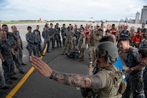 U.S. Air Force Maj. David Stuppy, 18th Air Evacuation Squadron standards and evaluations flight examiner, briefs personnel assigned to the 35th Medical Group and Japan Air Self-Defence Force on aeromedical operations for a mass casualty exercise during Resolute Force Pacific 2025 at Misawa Air Base, Japan, July 23, 2025.