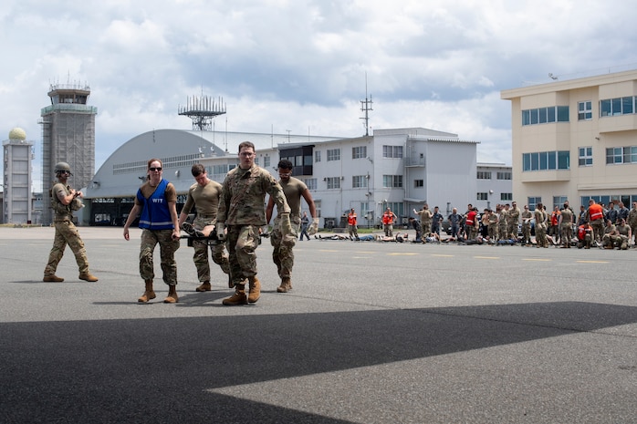 U.S. Air Force Airmen assigned to the 35th Medical Group walk a litter patient onto a C-130J Super Hercules assigned to the 36th Airlift Squadron for a mass casualty exercise during Resolute Force Pacific 2025 at Misawa Air Base, Japan, July 23, 2025.