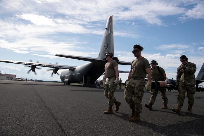 U.S. Air Force Airmen assigned to the 35th Medical Group execute an engine-running offload of a simulated litter patient for a mass casualty exercise during Resolute Force Pacific 2025 at Misawa Air Base, Japan, July 23, 2025.