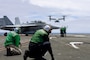 U.S. Navy Sailors direct a V-22 Osprey, assigned to the “Sunhawks” of Fleet Logistics Multi-Mission Squadron (VRM) 50, as it prepares to land on the flight deck of the Nimitz-class aircraft carrier USS Theodore Roosevelt (CVN 71), July 26, 2025.