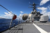 The Arleigh Burke-class guided-missile destroyer USS Milius (DDG 69) fires the Mark 45 5-Inch light-weight gun during a live-fire weapons exercise in the Indian Ocean, July 24, 2025.