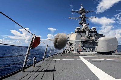 INDIAN OCEAN (July 24, 2025) — The Arleigh Burke-class guided-missile destroyer USS Milius (DDG 69) fires the Mark 45 5-Inch light-weight gun during a live-fire weapons exercise in the Indian Ocean, July 24, 2025. Milius is forward-deployed and...
