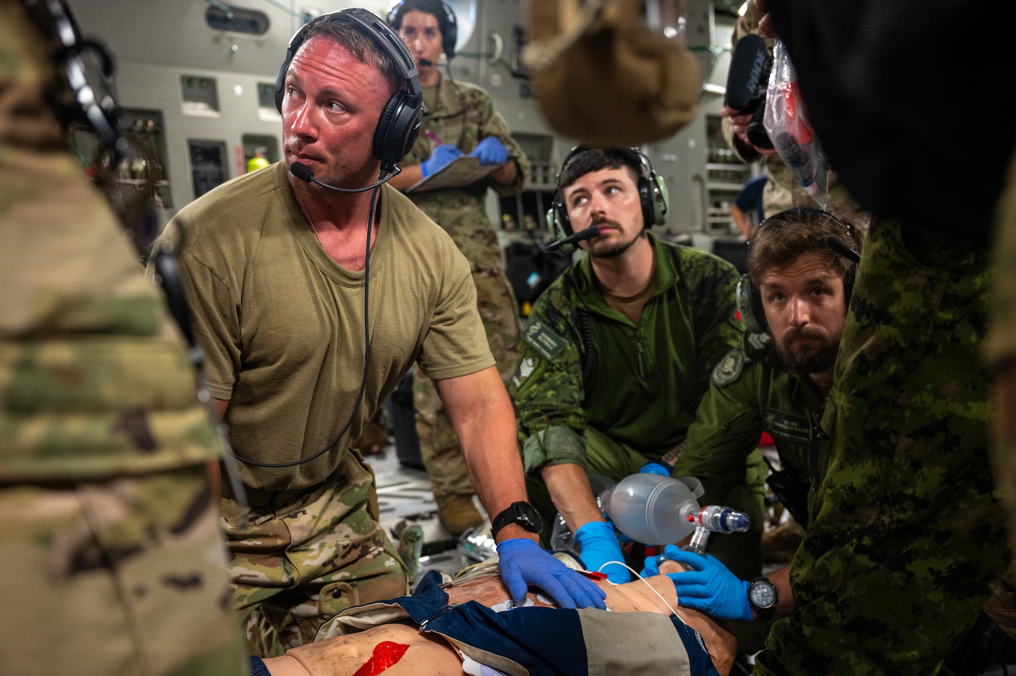 U.S. Air Force and Royal Canadian Air Force aeromedical evacuation members participate in a familiarization training on a U.S. Air Force C-17 Globemaster III aircraft assigned to the 60th Air Mobility Wing, during the Air Force's 2025 Department-Level Exercise series at Andersen Air Force Base, Guam, July 13, 2025. This exercise is part of the first-in-a-generation DLE series, a new way of conducting operations in a contested, dynamic environment to build capabilities making a stronger, more deterrent force. The DLE series encompasses all branches of the Department of Defense, along with Allies and partners, employing more than 400 Joint and coalition aircraft and more than 12,000 members at more than 50 locations across 3,000 miles. (U.S. Air Force photo by Senior Airman Brooklyn Golightly)