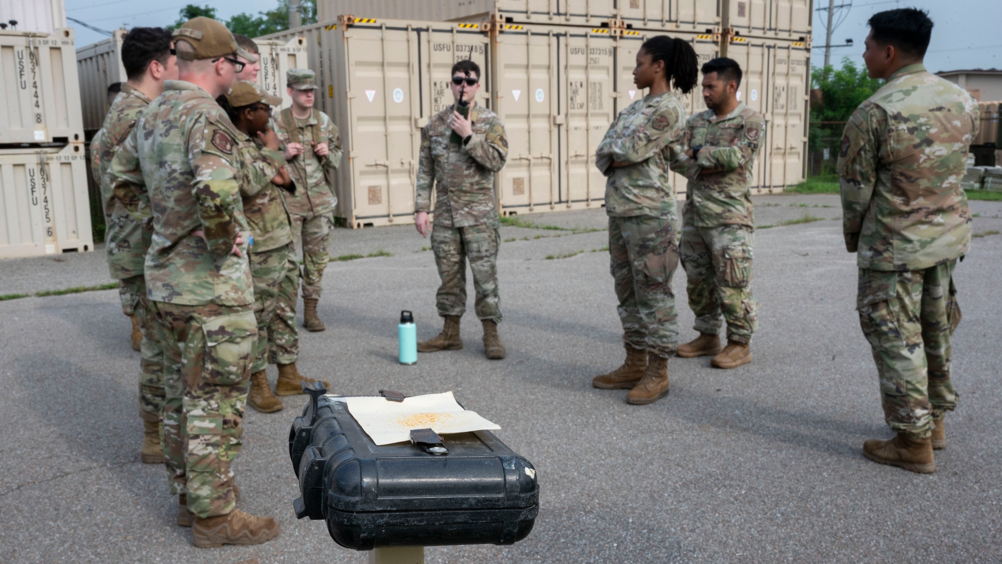 U.S. Air Force Senior Airman Drew Bertrand, center, 51st Logistics Readiness Squadron fuels service center controller, radios in a contamination at Osan Air Base, Republic of Korea, July 24, 2025. Teams were sent out during ability to survive and operate training in post-attack reconnaissance teams to search for possible contaminations, unexploded ordinances, and casualties in a contingency environment. (U.S. Air Force photo by Senior Airman Rome Bowermaster)
