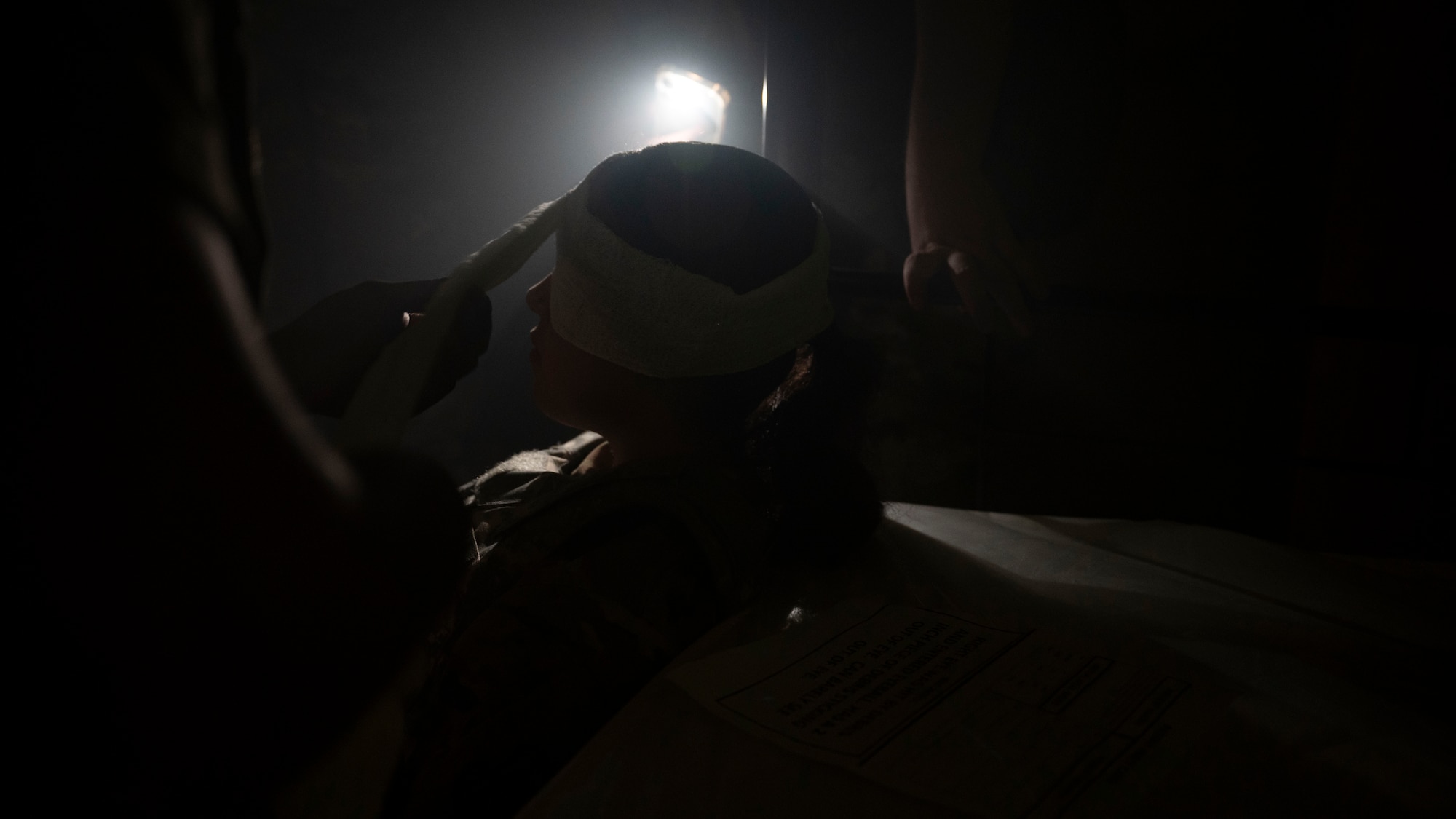U.S. Air Force Airmen assigned to the 51st Fighter Wing perform tactical combat casualty care at Osan Air Base, Republic of Korea, July 24, 2025. During the ability to survive and operate training, Airmen were split into two teams and given a realistic scenario where they were expected to demonstrate their TCCC training in a contingency environment. (U.S. Air Force photo by Senior Airman Rome Bowermaster)