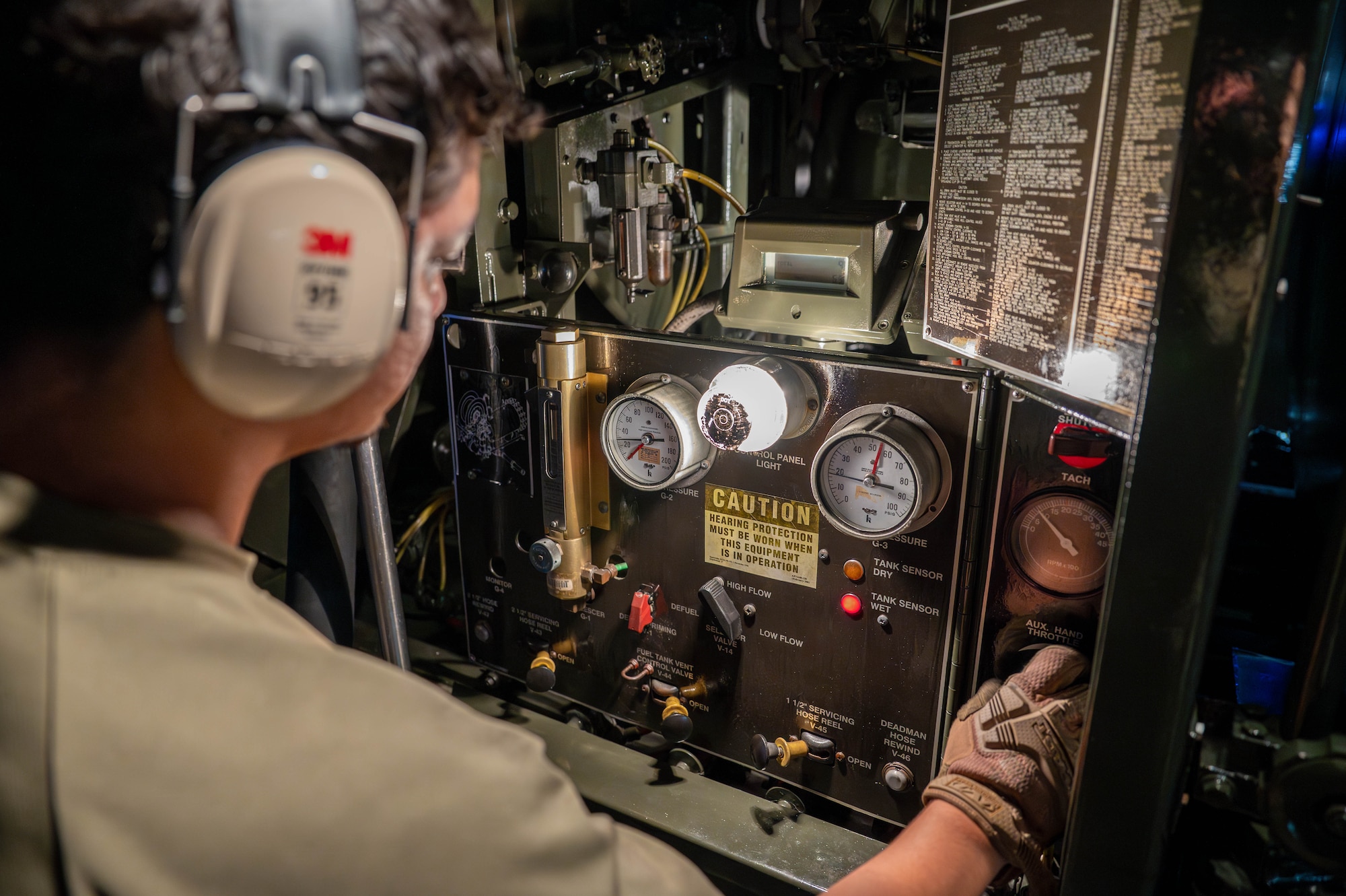 U.S. Air Force Airman 1st Class Giovanni Armenta, 18th Logistics Readiness Squadron fuels distribution operator, adjusts the auxiliary throttle on an R-11 refuel truck control panel.