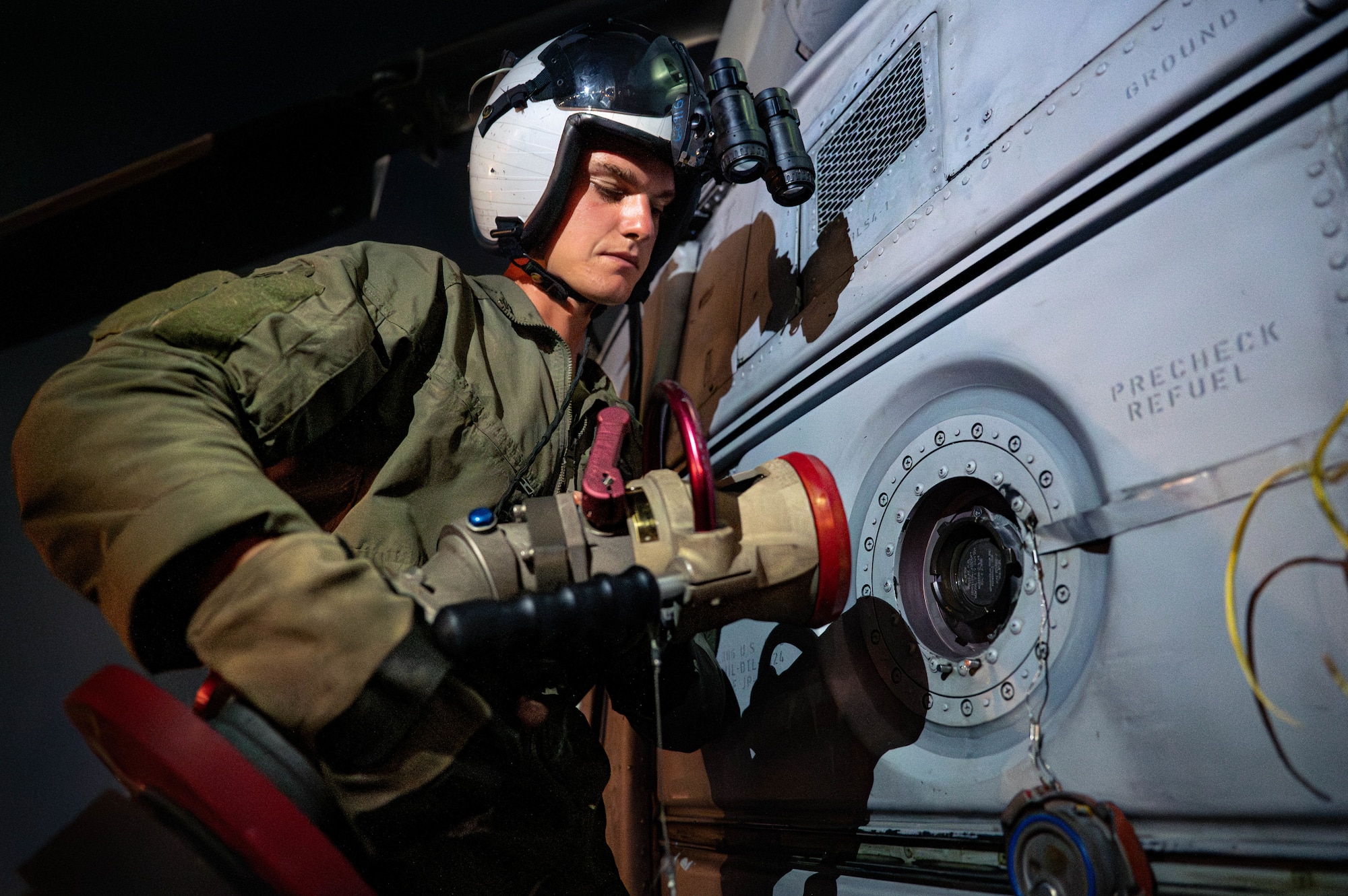 U.S. Marine Corps Lance Cpl. Maxwell Hunstad, Marine Light Attack Helicopter Squadron 169 UH-1Y crew chief, fuels a UH-1Y Venom assigned to HMLA-169, using an R-11 refueling truck hose.