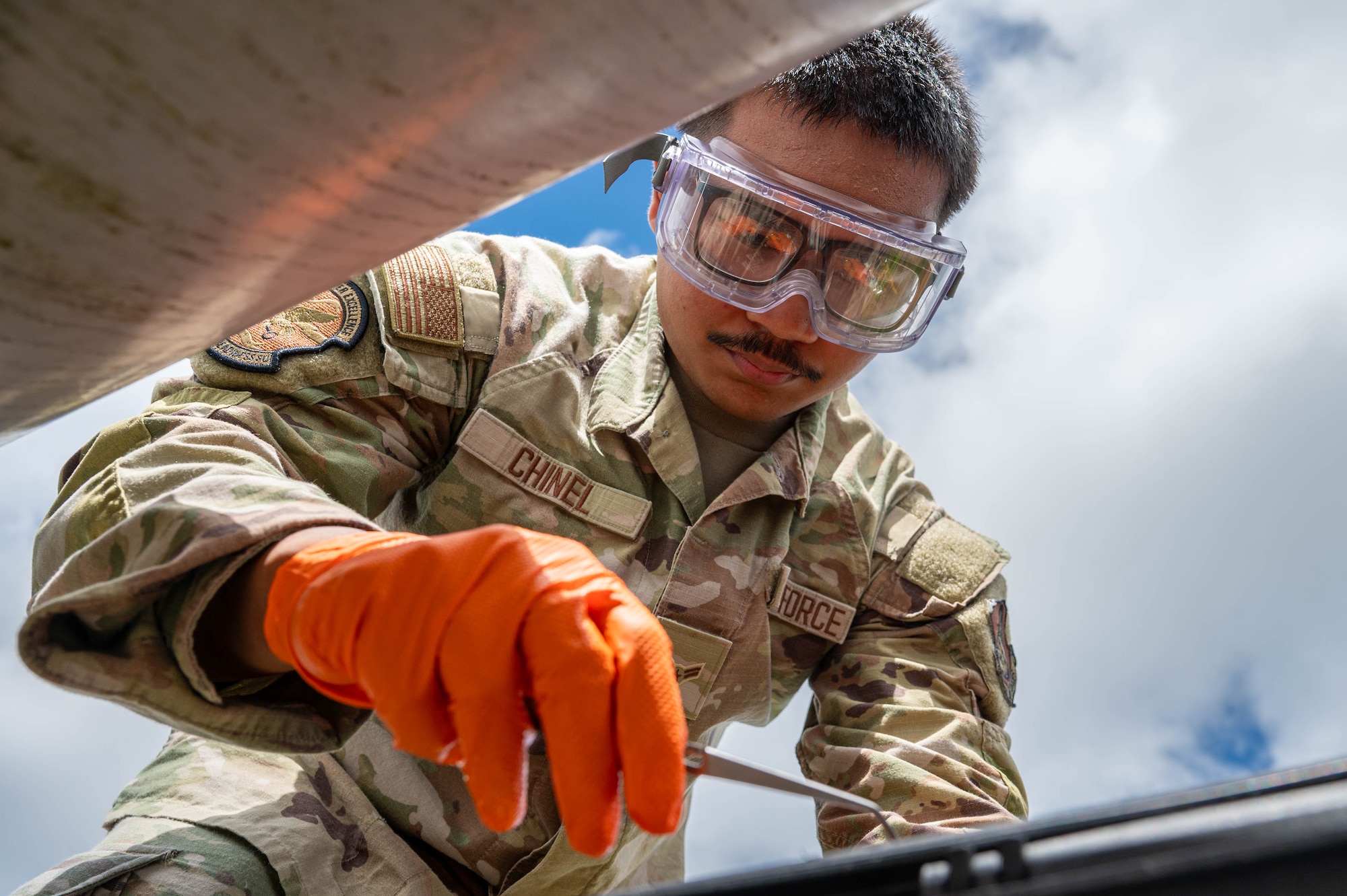 U.S. Air Force Airman 1st Class Gage Chinel, 18th Logistic Readiness Squadron laboratory technician, gathers raw fuel samples from a Defense Logistic Agency pipeline.